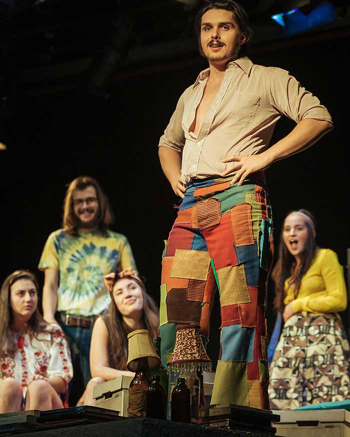 Actor Tomasz Pereira Nunes as Gerry in his patchwork pants on stage.
